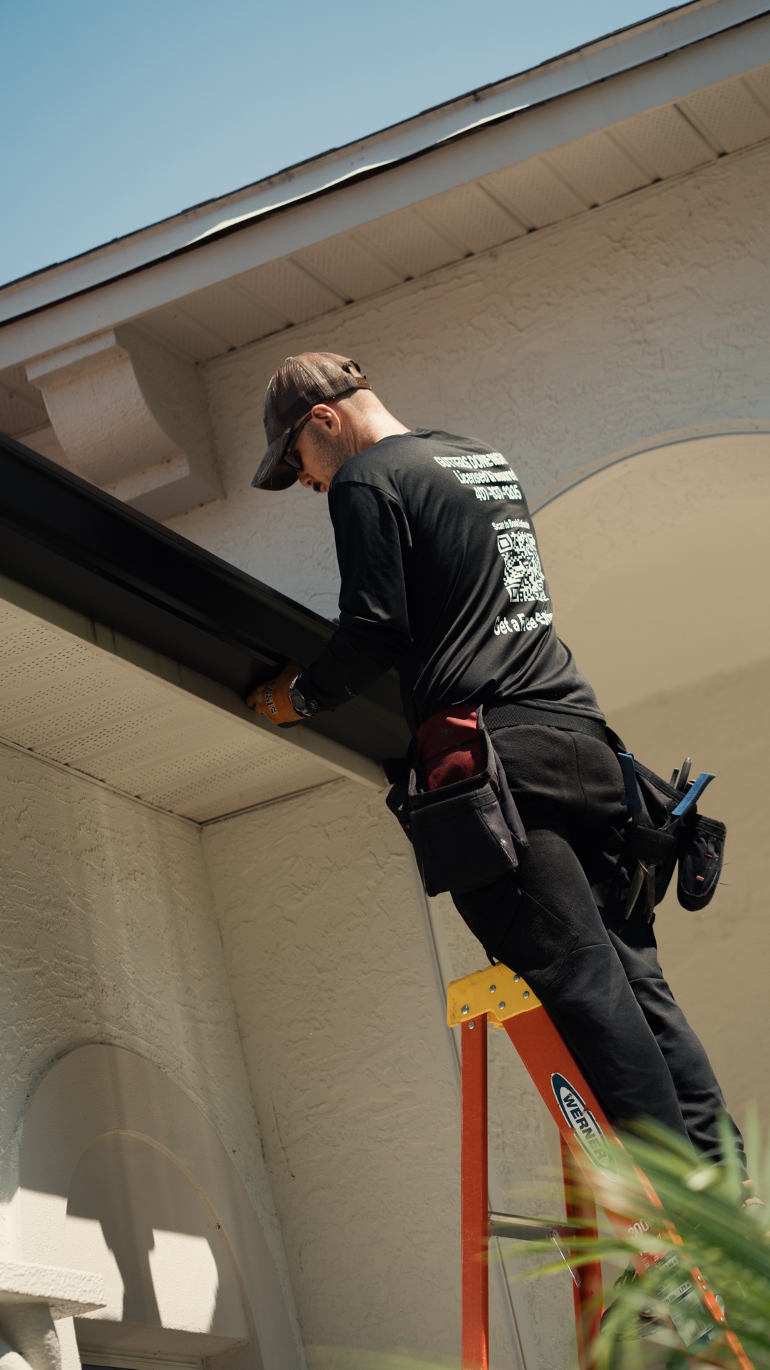 PrimeFlow installer securing a gutter and downspout system